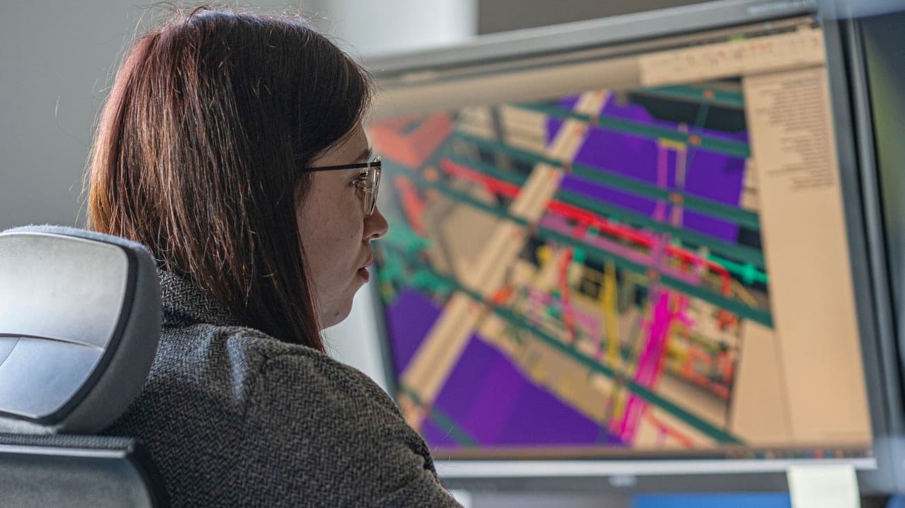 Person, sitting in front of a computer, planning technical building services